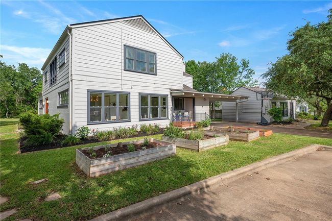 View of front of property featuring a garden and a front lawn | Image 50