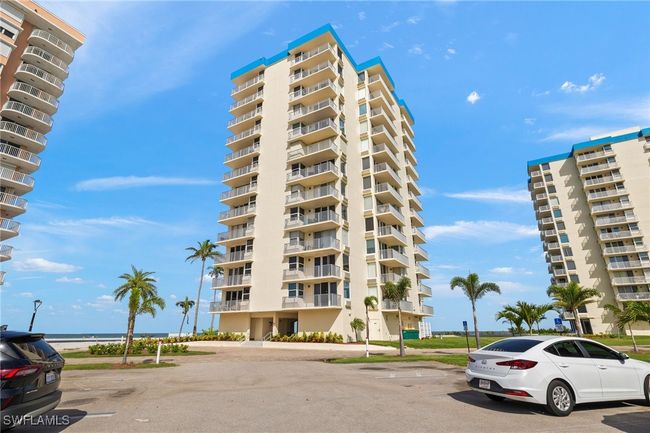 View of apartment building / complex with uncovered parking | Image 25
