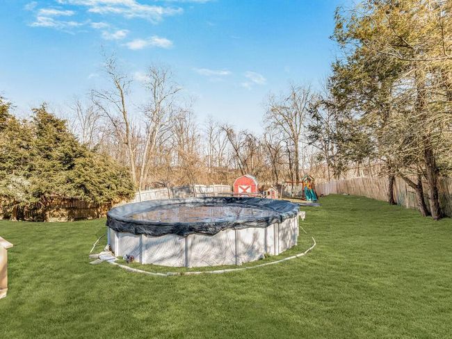 Fenced-in yard with pool to chill out on hot days. | Image 26