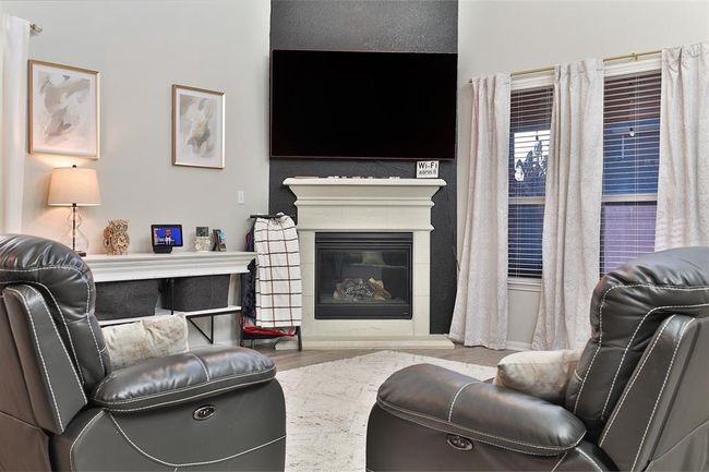 Embrace warmth and comfort by cozying up next to the fireplace. | Image 11
