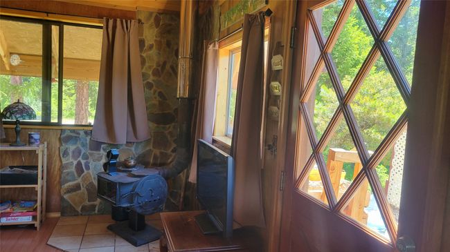 Living area with wood stove to the right of main entrance | Image 28