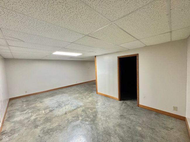 finished below grade area with a drop ceiling and baseboards | Image 61