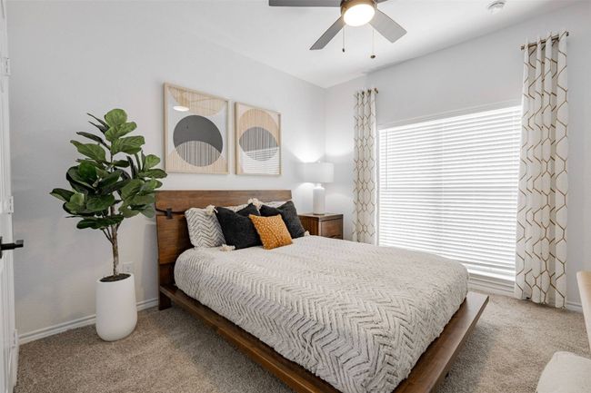 Bedroom with ceiling fan and carpet | Image 32