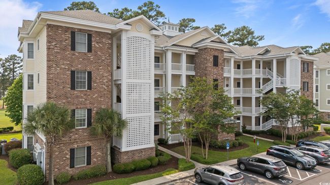 View of building exterior featuring uncovered parking | Image 16