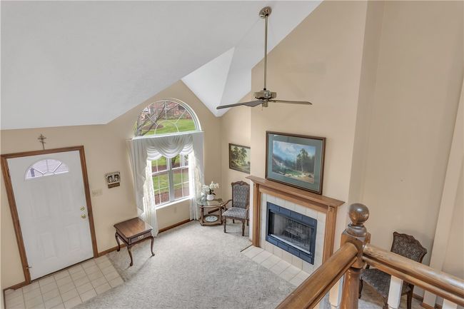 Tiled Front Entry into the Living Room with Beautiful Fireplace and Soaring, Vaulted Ceiling. | Image 4