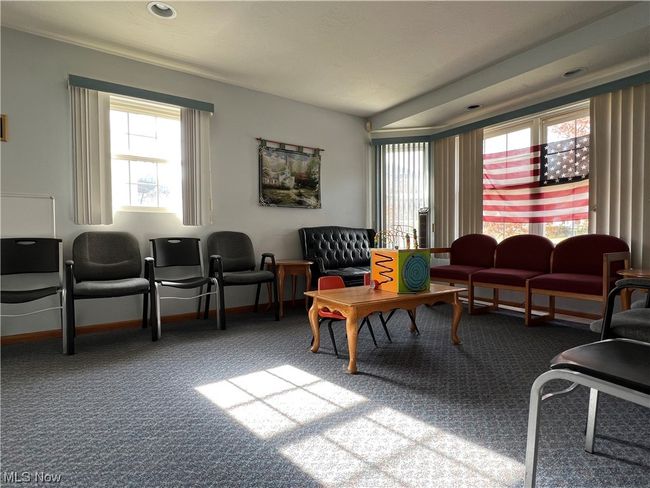 Living room featuring light colored carpet | Image 6