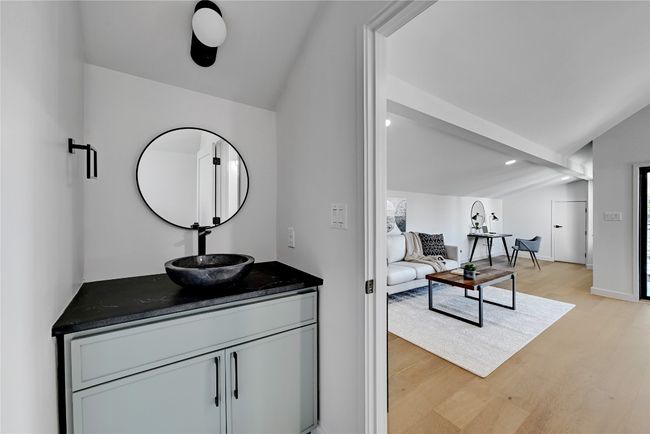 Bathroom with vanity, vaulted ceiling, and wood-type flooring | Image 19