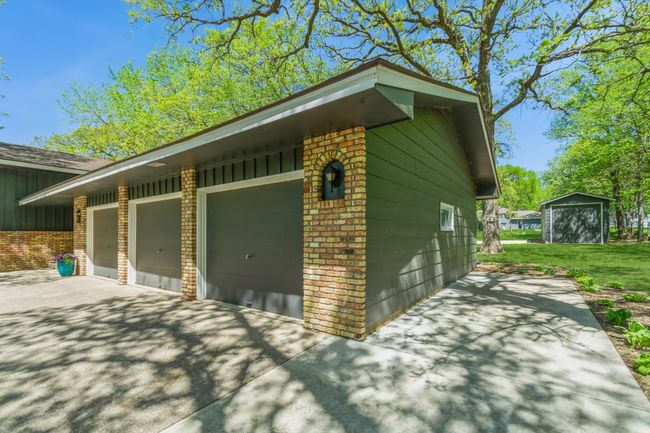 Extra concrete parking pad located just off the 3 stall garage...Check out your back shed from this view! | Image 47