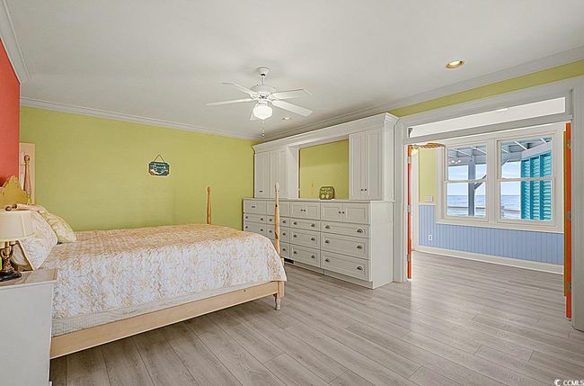 Bedroom featuring light wood-type flooring, ceiling fan, crown molding, and recessed lighting | Image 24