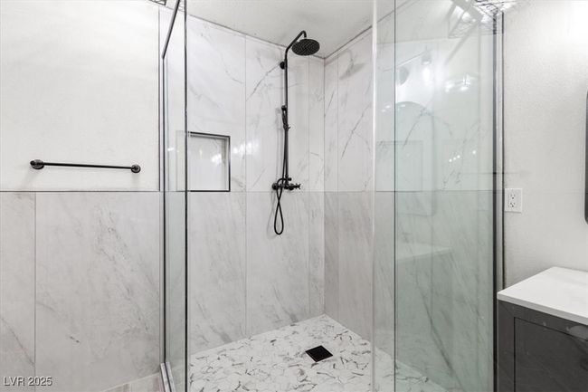 Full bath with a marble finish shower and vanity | Image 21