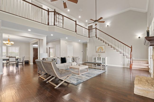 View of living room, formal dining and grand staircase from kitchen dining area | Image 13