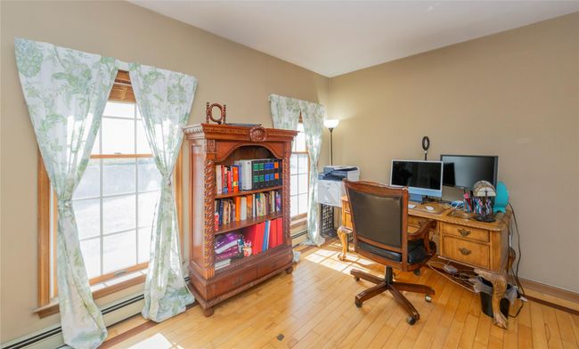 Office area with hardwood / wood-style flooring and baseboard heating | Image 26