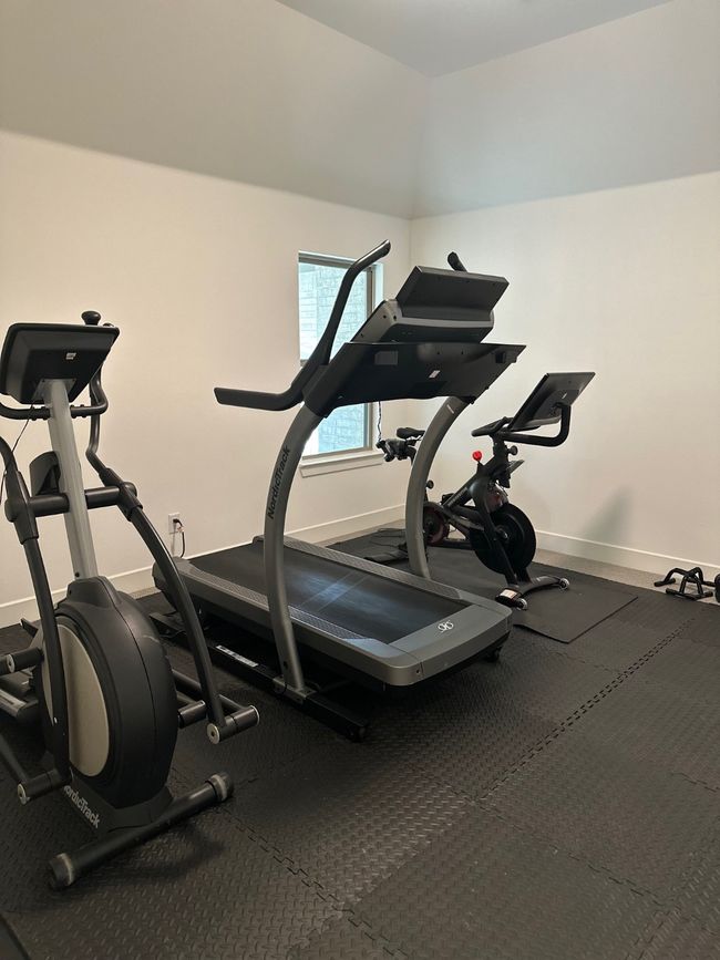 Exercise room featuring lofted ceiling and baseboards | Image 35
