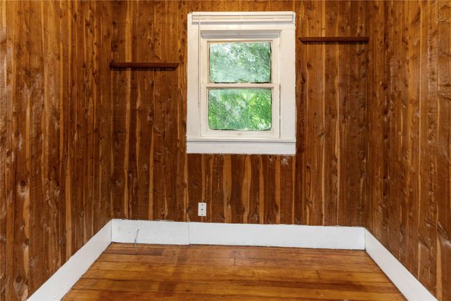 Spare room with wood walls and wood finished floors | Image 14