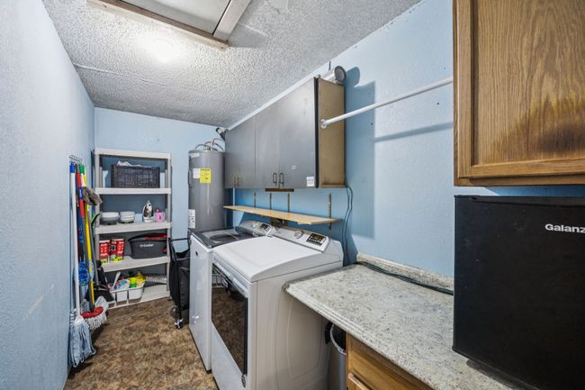 The laundry room has lots of room and built in storage. | Image 22