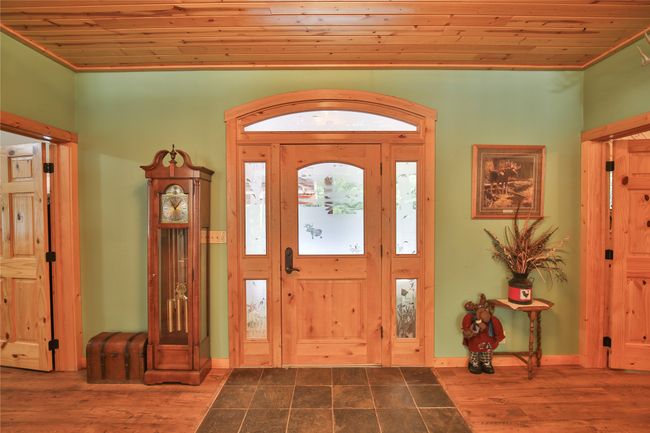 Entrance foyer with dark wood finished floors, wooden ceiling, and baseboards | Image 13