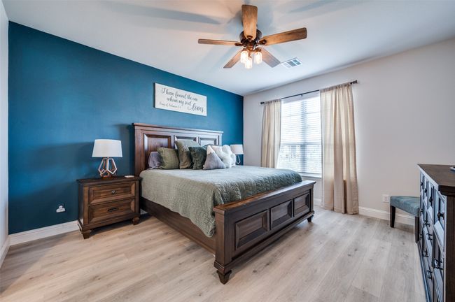 Bedroom with visible vents, baseboards, ceiling fan, and light wood-style floors | Image 9