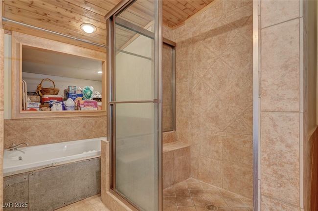 Full bathroom with a stall shower, a bath, wooden ceiling, and tile patterned floors | Image 45