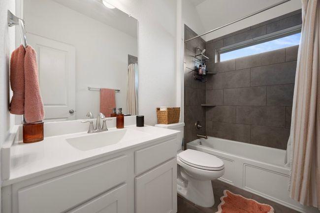 Bathroom with toilet, vanity, and shower / tub combo with curtain | Image 17