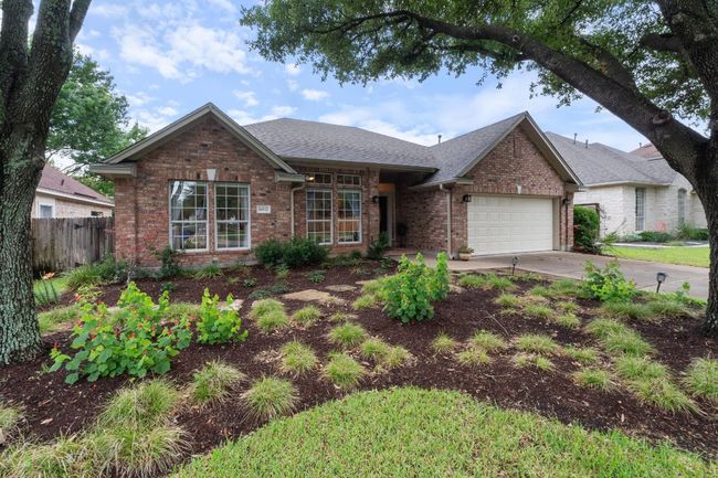 1_story ranch with brick exterior and professionally landscaped yard. | Image 4