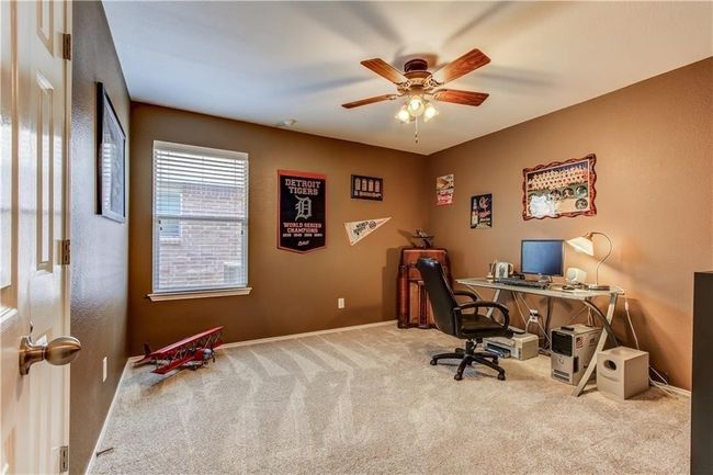 Carpeted office featuring a ceiling fan and baseboards | Image 10