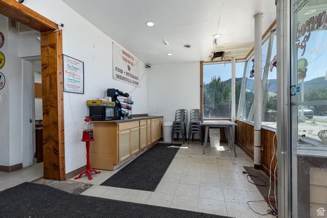 Interior space with a mountain view and a healthy amount of sunlight | Image 15