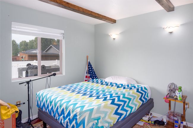 Bedroom with beamed ceiling and baseboards | Image 50