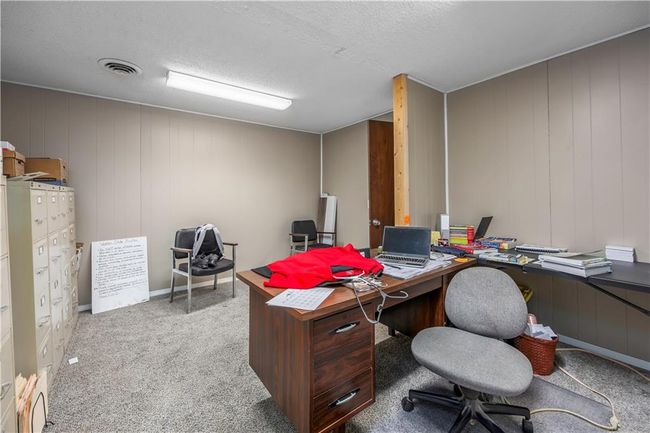 Home office featuring visible vents, a textured ceiling, and carpet flooring | Image 22