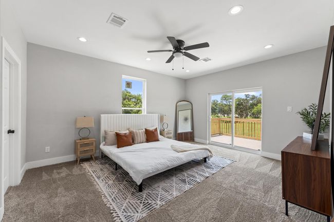 Spacious primary bedroom with direct balcony access and serene lake views. | Image 15