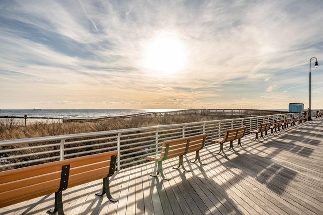 Boardwalk at dusk with a view of the beach and a water view | Image 35