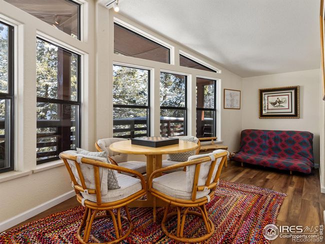 Large foyer serves as a great rec room area with a wall of windows looking out to the tree tops and snowy peaks | Image 11