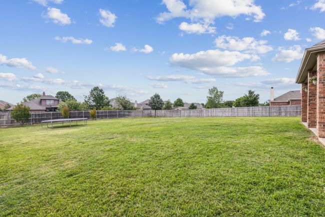 View of yard featuring a fenced backyard and a trampoline | Image 29