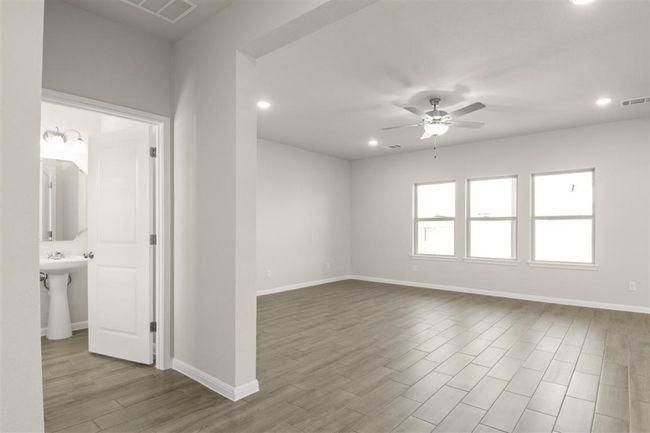 Unfurnished room with visible vents, baseboards, a ceiling fan, and wood finished floors | Image 4