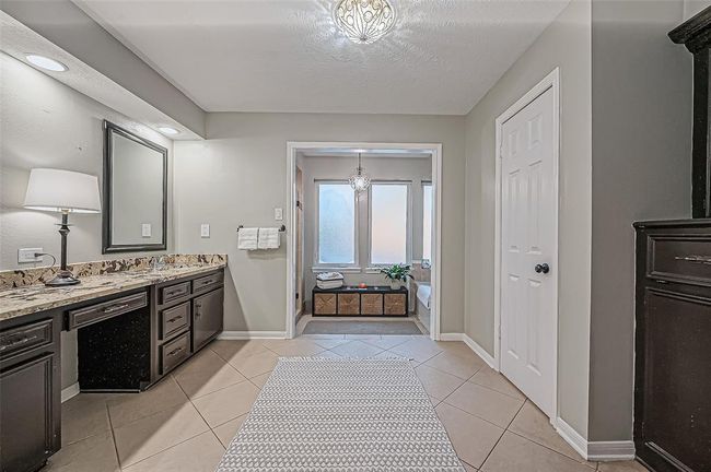 Luxurious primary bathroom featuring a spacious walk-in shower and a separate soaking tub. | Image 28