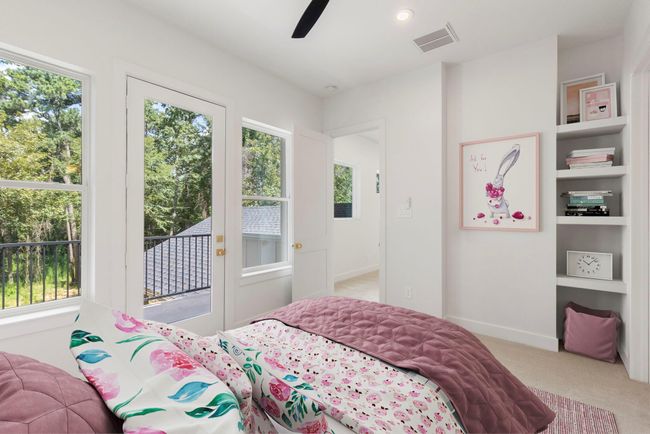 Secondary bedroom upstairs with its own closet, ensuite bath, custom shelving, closet and private balcony! | Image 25