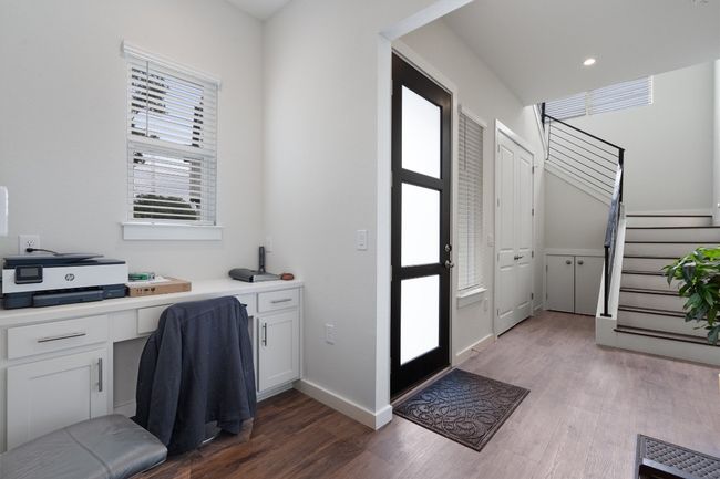 Home office with built in desk and wood finished floors | Image 15