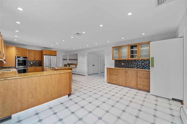 Kitchen with stainless steel appliances, light floors, tasteful backsplash, recessed lighting, and glass insert cabinets | Image 8