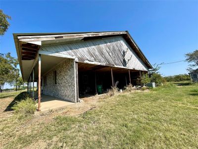 View of side of home with a yard | Image 2