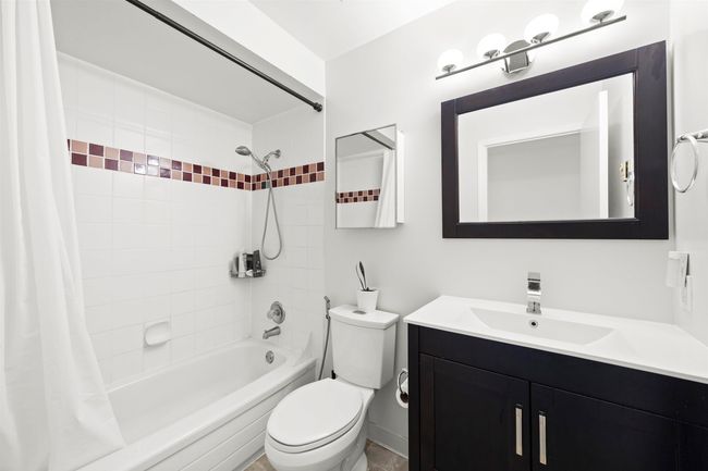 Full bath featuring shower / bath combo, vanity, and toilet | Image 23