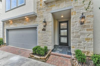 No expense was spared on this modern townhouse in The Heights-including this stone entry way with triple panel glass and wood door. | Image 2