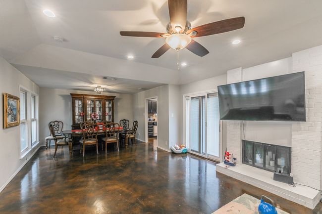 Unit 4904 Dining room featuring a brick fireplace and ceiling fan | Image 26