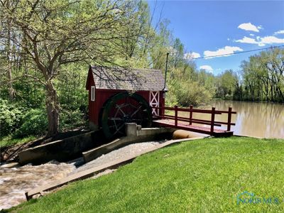 This water wheel is located at the entrance of the community on your way to Lot #6. | Image 2