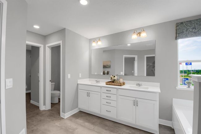 The large primary suite is an oasis and offers a private bath and two walk in closets. Model photos. Options and colors will vary. | Image 23