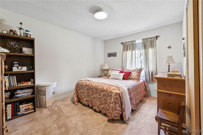 Bedroom with carpet floors and a textured ceiling | Image 14