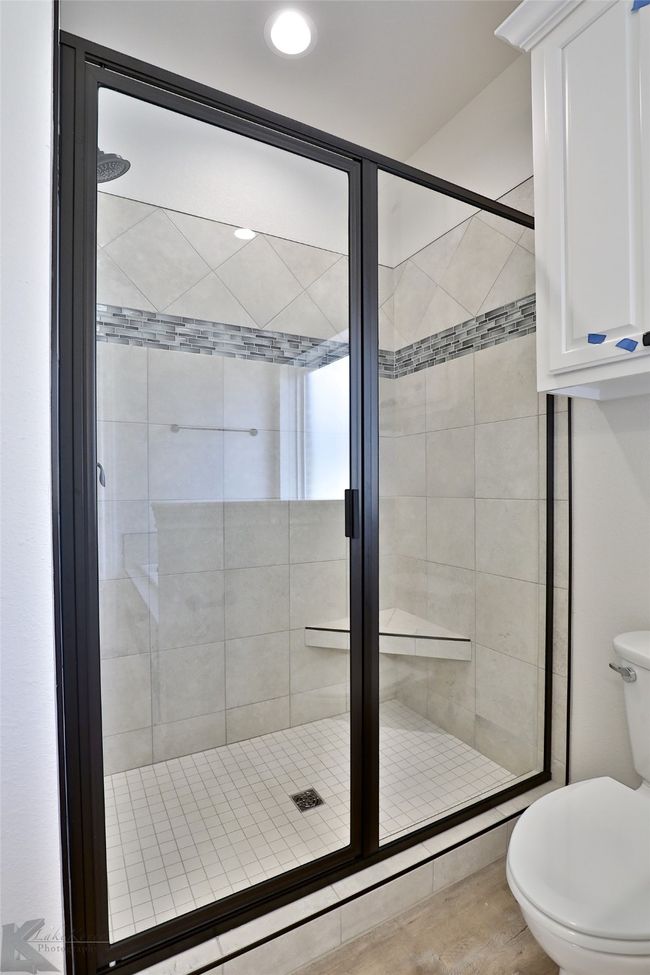 Bathroom with a stall shower and wood finished floors | Image 17