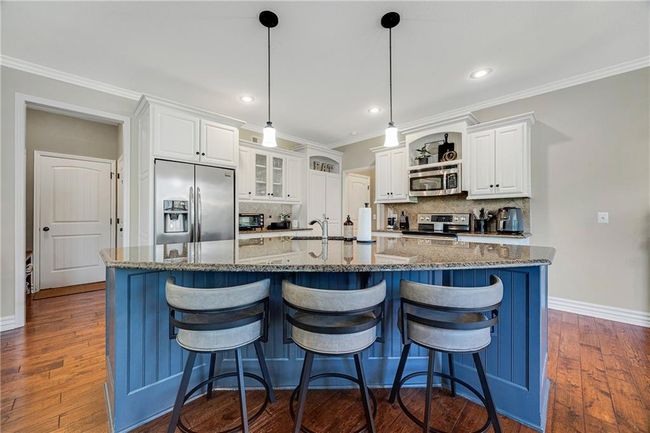 Kitchen island with granite counter tops. | Image 12
