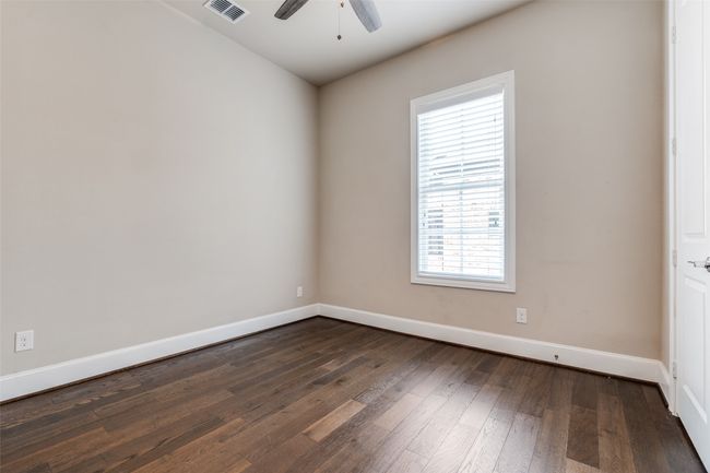 Unfurnished room featuring plenty of natural light, ceiling fan, and dark wood-style floors | Image 22