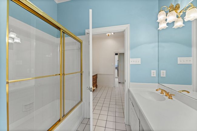 Bathroom with vanity, combined bath / shower with glass door, and crown molding | Image 23