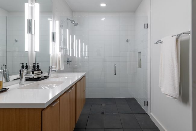 Full bathroom featuring a shower stall, tile patterned flooring, and a sink | Image 22