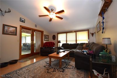 Living room featuring lofted ceiling, french doors, and ceiling fan | Image 3